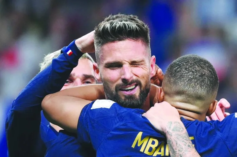 France’s forward Olivier Giroud celebrates with teammates after scoring against Australia during the Group D match at the Al Janoub Stadium in Al Wakra yesterday. (AFP)