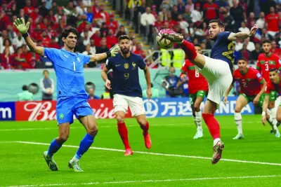 France’s defender Theo Hernandez strikes the ball to score his team’s first goal past Morocco’s goalkeeper Yassine Bounou during the Qatar 2022 World Cup semi-final against Morocco at the Al Bayt Stadium in Al Khor yesterday. (AFP)