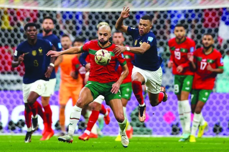 Morocco's midfielder Sofyan Amrabat and France's forward Kylian Mbappe fight for ball possession during the Qatar 2022 World Cup semi-final at the Al-Bayt Stadium in Al Khor, north of Doha, on Wednesday. (AFP)