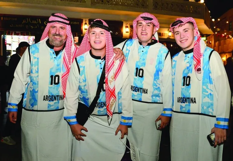 Some Argentine fans in Qatari headgear.