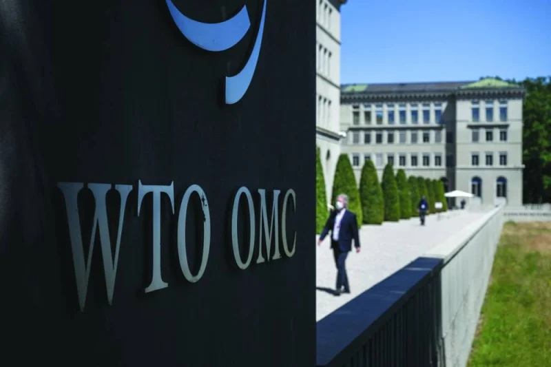 A man walks near a sign of the World Trade Organisation at the WTO headquarters in Geneva. WTO ministerial meetings are generally held biennially and often provide political impetus to advance international trade negotiations.