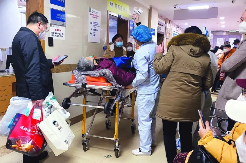 A Covid-19 patient on a stretcher is taken to the emergency ward of the First Affiliated Hospital of Chongqing Medical University in China’s southwestern city of Chongqing yesterday. 