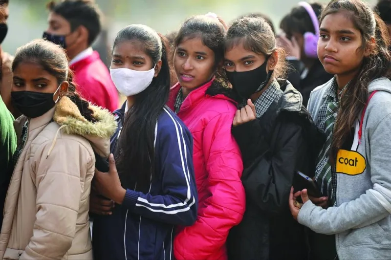 School students wear mask as a precaution against the Covid-19 coronavirus while they walk near India Gate, in New Delhi, yesterday.
