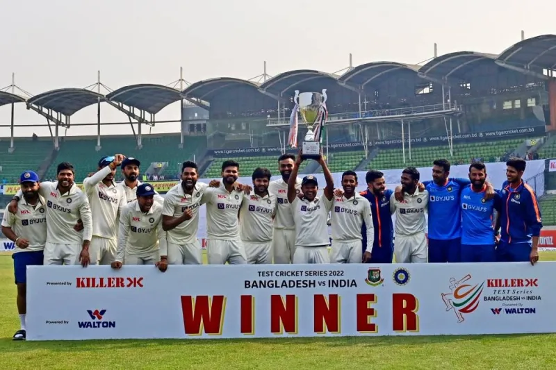 India’s cricketers pose for a photo as they hold the tournament trophy after winning on the fourth day of the second cricket Test match between Bangladesh and India (AFP)