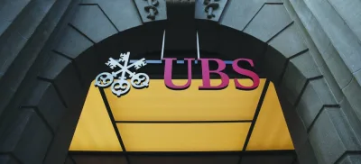 A sign hangs above the entrance to the UBS Group headquarters in Zurich. The Bank of Japan’s policy move has roiled global markets, but a gaggle of funds stand to benefit — including UBS Asset Management, Schroders and BlueBay Asset Management.