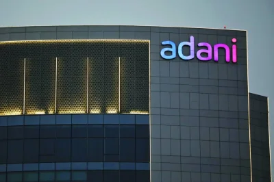 The logo of the Adani Group is seen on the facade of one of its buildings on the outskirts of Ahmedabad, India. Adani’s ports-to-power conglomerate saw at least two of seven listed companies more than double in value this year, led by Adani Power Ltd as it benefited from a jump in demand for electricity.