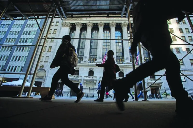 Pedestrians walk past the New York Stock Exchange. The world faces a recession in 2023 as higher borrowing costs aimed at tackling inflation cause a number of economies to contract, according to the Centre for Economics and Business Research.