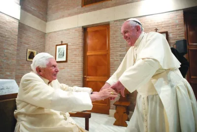 This photo taken on November 28, 2020 by The Vatican Media shows Pope Francis (right) greeting Pope Emeritus Benedict XVI following a consistory to create 13 new cardinals the same day in The Vatican. (AFP)