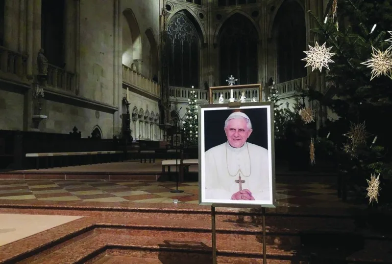 A portrait of Pope Emeritus Benedict XVI seen near the altar at the Cathedral of Regensburg, southern Germany, yesterday, during a church service. (AFP)