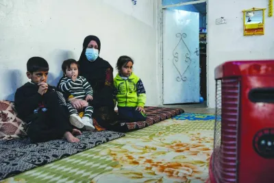 Alia Abdel-Razak,  a woman deprived of crucial civil status documents, is pictured with 3 of her children in her home in Iraq's northern city of Mosul.