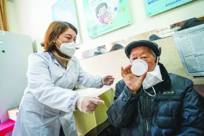 A health worker administering a dose of CanSino Biologics inhalable Covid-19 coronavirus vaccine in Bijie.