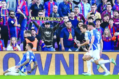 Espanyol’s Joselu (left) celebrates scoring against Barcelona during the La Liga match in Barcelona yesterday. (AFP)