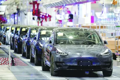 Tesla's China-made Model 3 vehicles are seen during a delivery event at its factory in Shanghai (file). Reuters reported on Wednesday that Tesla planned to run a reduced production schedule at its Shanghai plant in January, extending the reduced output it began this month into next year.