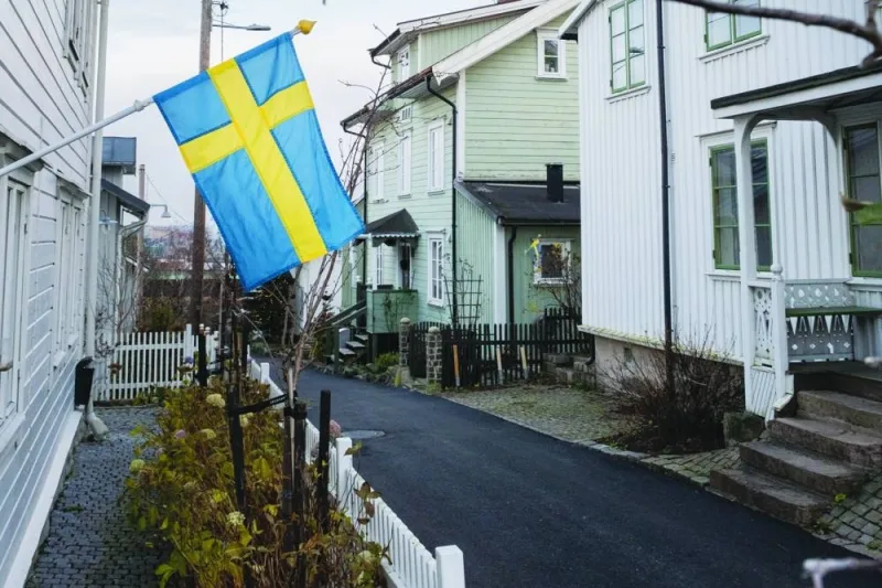 A Swedish national flag outside a detached house in the Slottsberget district of Gothenburg. The drop for home prices in Sweden continued unabated in the last month of the year, suggesting that 2023 could offer little relief for an already troubled housing market.