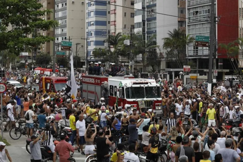 Fans of the late Brazilian football star Pele gather on the street as a firetruck transports Pele&#039;s coffin to the Santos&#039; Memorial Cemetery in Santos, Sao Paulo state, Brazil on January 3. AFP