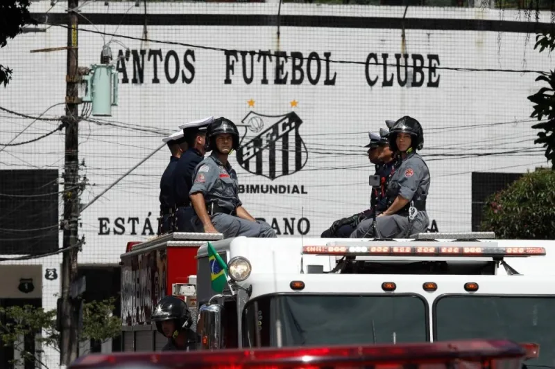 The coffin of the late Brazilian football is transported on a firetruck outside the Urbano Caldeira stadium during a funeral procession to the Santos&#039; Memorial Cemetery in Santos, Sao Paulo state, Brazil on January 3. AFP