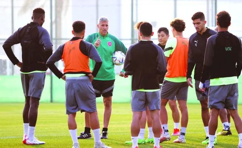 Al Duhail coach Hernan Crespo talks to his players at a training session. 