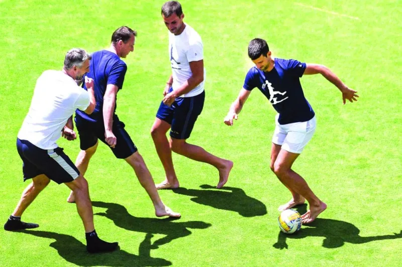 Serbia’s Novak Djokovic (right) plays football with his team after winning his against France’s Constant Lestienne in Adelaide. (AFP)
