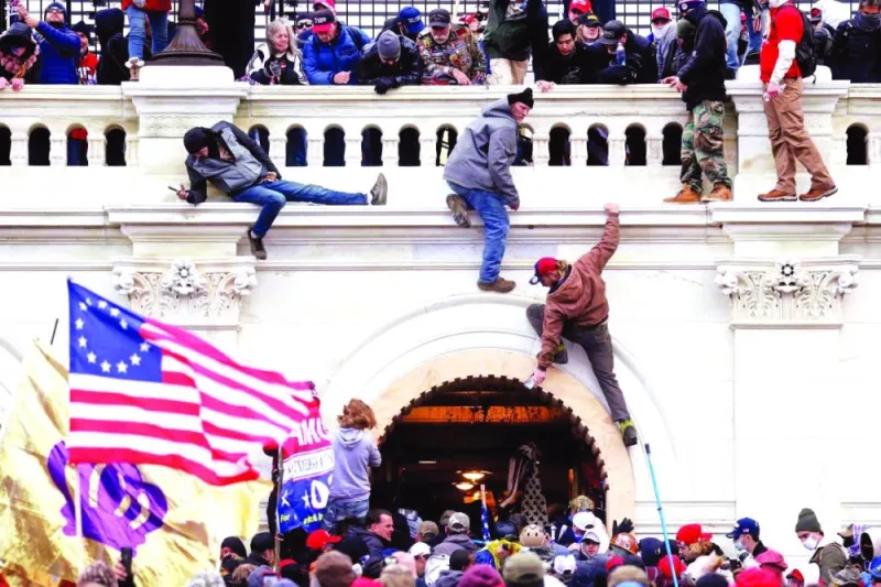 A mob of Trump supporters fight with members of law enforcement at a door they broke open as they stormed the Capitol on January 6 in 2021.