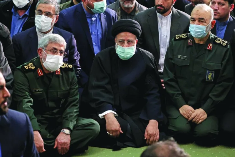 Iranian President Ebrahim Raisi alongside commander of the Quds Force of the Islamic Revolutionary Guard Corps Esmail Qaani (left) and head of Iran’s Islamic Revolutionary Guard Corps (IRGC) Hossein Salami (right) attend a commemoration ceremony in the capital Tehran, yesterday.