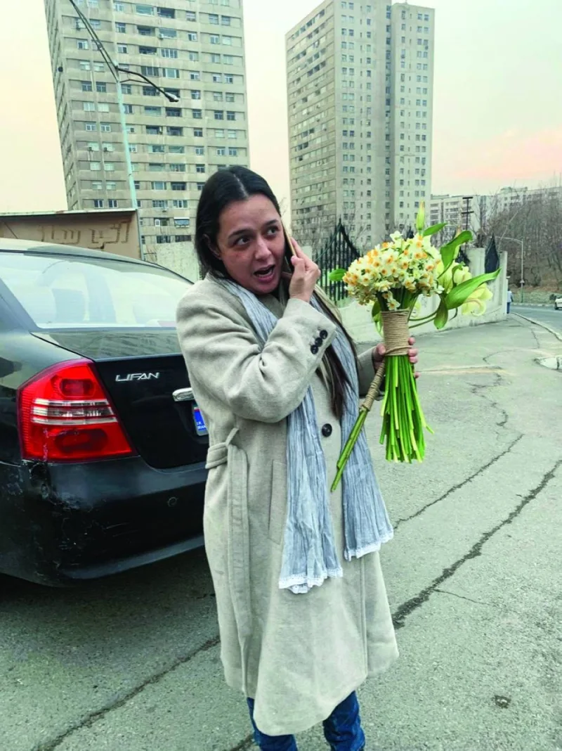 Iranian actor Taraneh Alidoosti holds flowers after her release from Evin prison, in Tehran, yesterday.