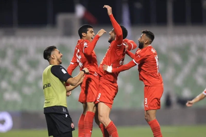 Al Arabi&#039;s Omar al-Somah celebrates with teammates after scoring against Al Ahli in the QNB Stars League at Hamad Bin Khalifa Stadium on Thursday.