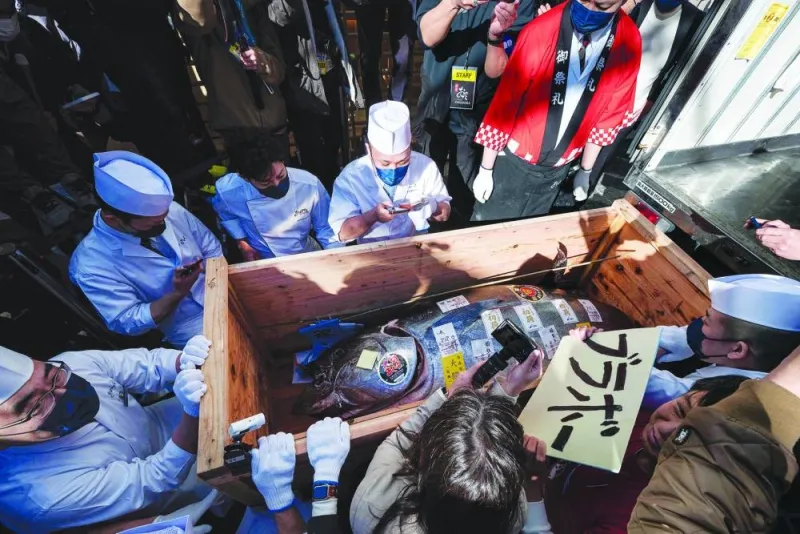 A crate holding a bluefin tuna, which was purchased earlier in the day for over $270,000 at the first tuna auction of the New Year, is unloaded outside the Sushi Ginza Onodera main store in Omotesando in Tokyo.