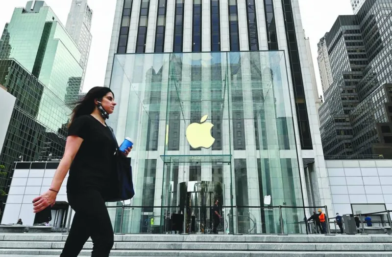 A person walks past the Apple store on Fifth Avenue in New York City. Investors are no longer turning a blind eye to risks facing Apple, an about-face that has taken the iPhone maker’s market value below tn and threatens more pain for the stock in the months ahead.