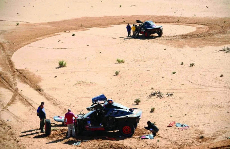A view of the Audi hybrids of Spain’s Carlos Sainz (left) and France’s Stephane Peterhansel is pictured after a crash during Dakar Rally yesterday. (AFP)