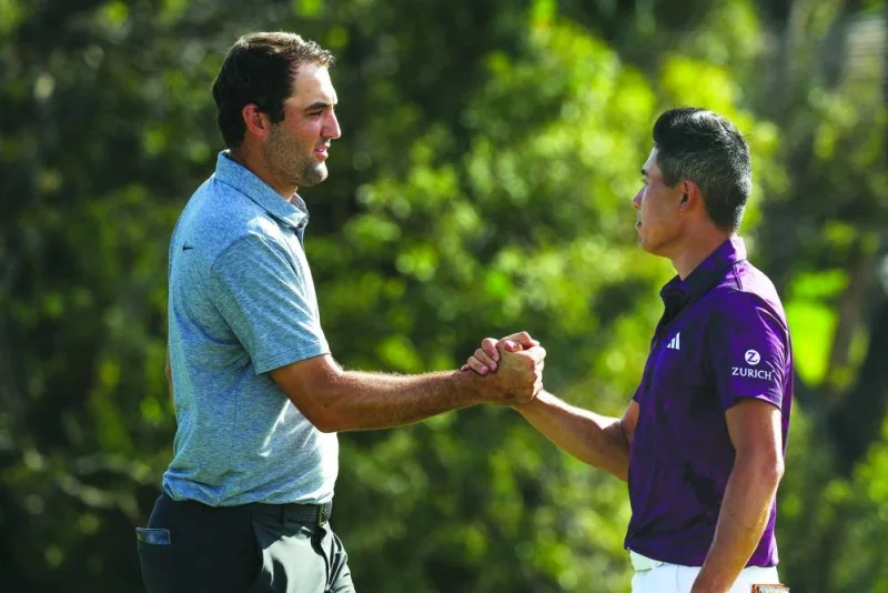 Scottie Scheffler (left) of the US and compatriot Collin Morikawa shake hands on the 18th green during the third Collin Morikawa fired an eagle and six birdies on Saturday to push his lead at the US PGA Tour Tournament of Champions to six strokes heading into the final round.(AFP)