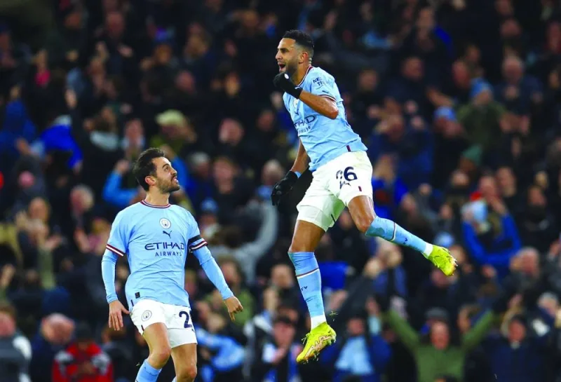 Manchester City’s Riyad Mahrez celebrates with Bernardo Silva after scoring against Chelsea during the FA Cup match at the Etihad Stadium in Manchester yesterday. (Reuters)