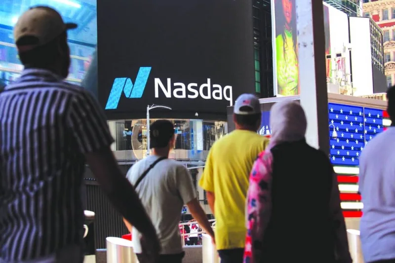 Pedestrians in front of the Nasdaq MarketSite in New York. The tech-heavy Nasdaq 100 fell 33% last year, its biggest annual drop since 2008. While it is up less than 1% in 2023, Apple, Microsoft, and Alphabet all remain in negative territory.