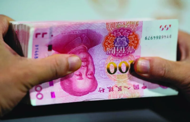 An employee counts out 100 yuan notes at a bank in Shanghai. Chinese banks extended 1.4tn yuan ($206.7bn) in new yuan loans in December, up from November and beating analysts’ expectations, according to data released by the People’s Bank of China.