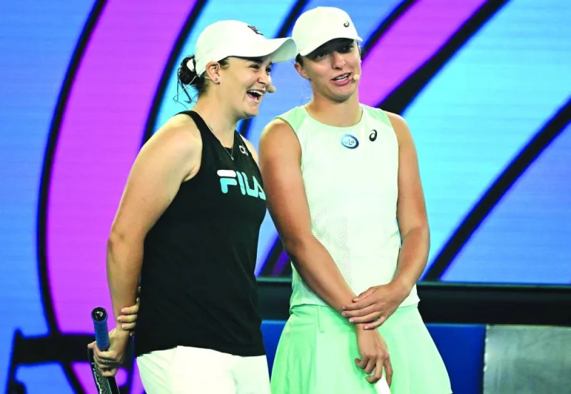 Ashleigh Barty (left) and Iga Swiatek attend an event of ‘Kids Tennis Day’ in Melbourne yesterday. (AFP)