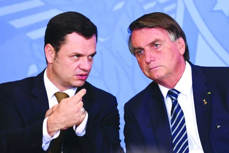 This photograph taken on June 27, 2022 shows then-Brazilian president Jair Bolsonaro (right) and then-justice minister Torres.