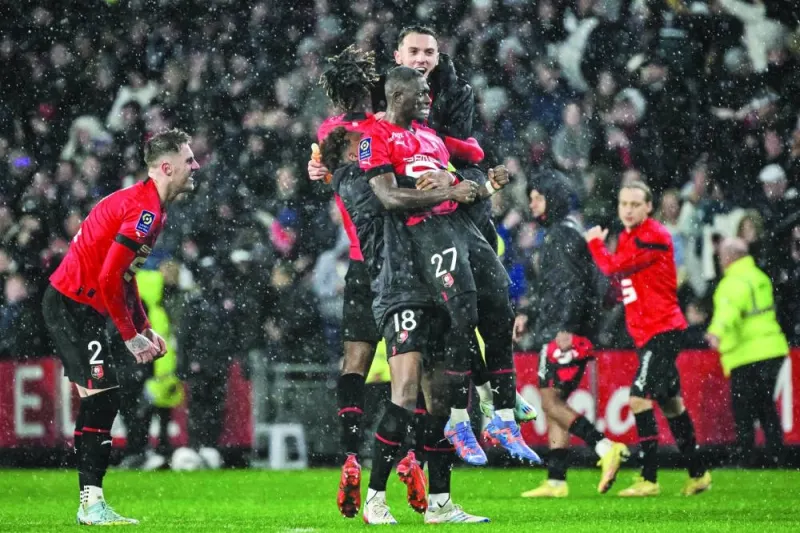 Rennes’ Malian defender Hamari Traore celebrates with teammates after their win over Paris Saint-Germain in the French Ligue 1 at the Roazhon Park stadium in Rennes, western France, on Sunday. (AFP)