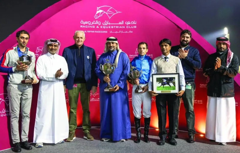 The connections of Inverness celebrate after Wathnan Racing-owned bay colt won the Khor Al Adaid Cup yesterday. The Alban Elie De Mieulle-trained horse was ridden to victory by Ronan Thomas. Qatar Equestrian Federation Secretary-General Ali Al Rumaihi presented the trophy to the winners. PICTURES: Juhaim