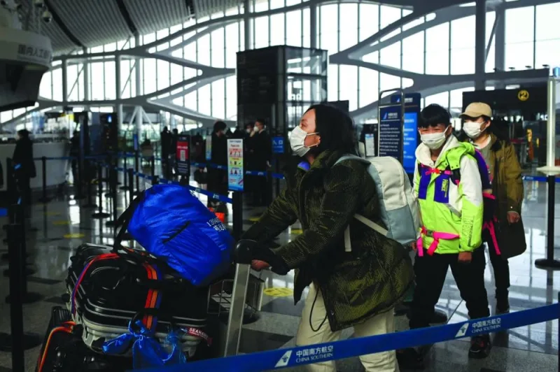 Passengers prepare to check in at Daxing International airport in Beijing on Thursday.