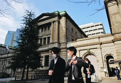 People walk at the headquarters of Bank of Japan in Tokyo. Global funds will pressure the BoJ until it capitulates and tightens policy, after the central bank disappointed bond bears by refusing to lift its ceiling on sovereign yields.