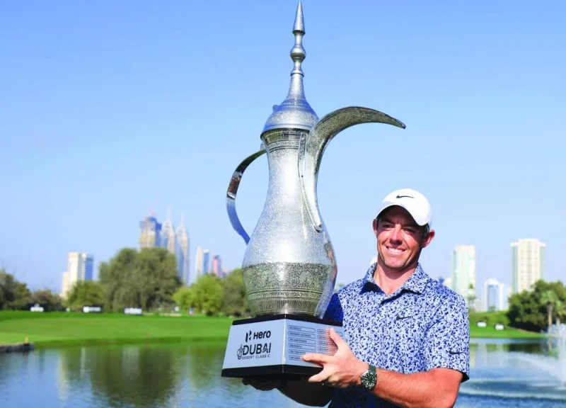 Rory McIlroy of Northern Ireland lifts the trophy after winning the final round of the Dubai Desert Classic 2023 Championship at the Emirates Golf Club in Dubai yesterday. (AFP)