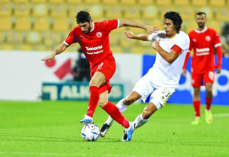 Qatar SC’s Sebastian Soria (right) vies for the ball with Al Arabi’s Yousuf Muftah.