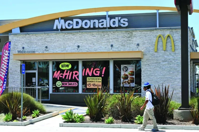 A man walks past a 'Hiring' sign at a McDonald's restaurant in Garden Grove, California (file). The blockbuster January jobs report is likely to strengthen the Federal Reserve’s determination to raise interest rates above 5% and keep them high throughout the year — an outcome investors remain sceptical of.