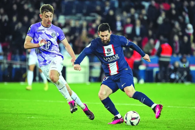 Paris Saint-Germain’s Lionel Messi (right) vies for the ball with Toulouse’s Anthony Rouault during the Ligue 1 match in Paris yesterday. (AFP)