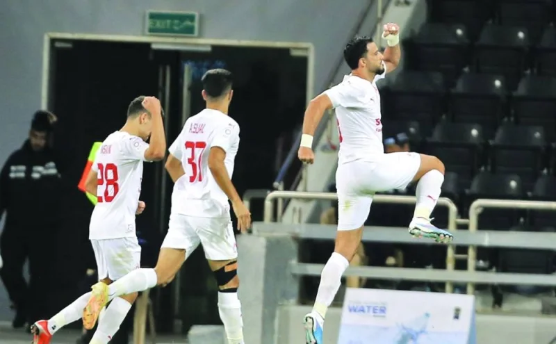 Al Arabi's Omar al-Somah’s celebrates after scoring against Al Rayyan.
