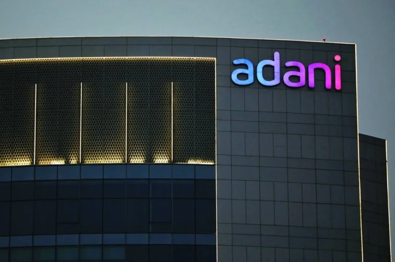 The logo of the Adani group is seen on the facade of one of its buildings on the outskirts of Ahmedabad, India. Six of the group’s 10 stocks ended lower in Mumbai on Monday, with Adani Transmission Ltd and Adani Total Gas Ltd leading the losses.