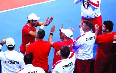 Croatia’s Borna Coric celebrates with team members after winning against Austria’s Dominic Thiem during their singles match of the Davis Cup qualifying round in Rijeka. (AFP)