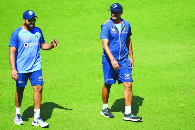 India&#039;s captain Rohit Sharma (left) speaks with his team coach Rahul Dravid during a practice session at the Vidarbha Cricket Association (VCA) Stadium in Nagpur on Tuesday. (AFP)