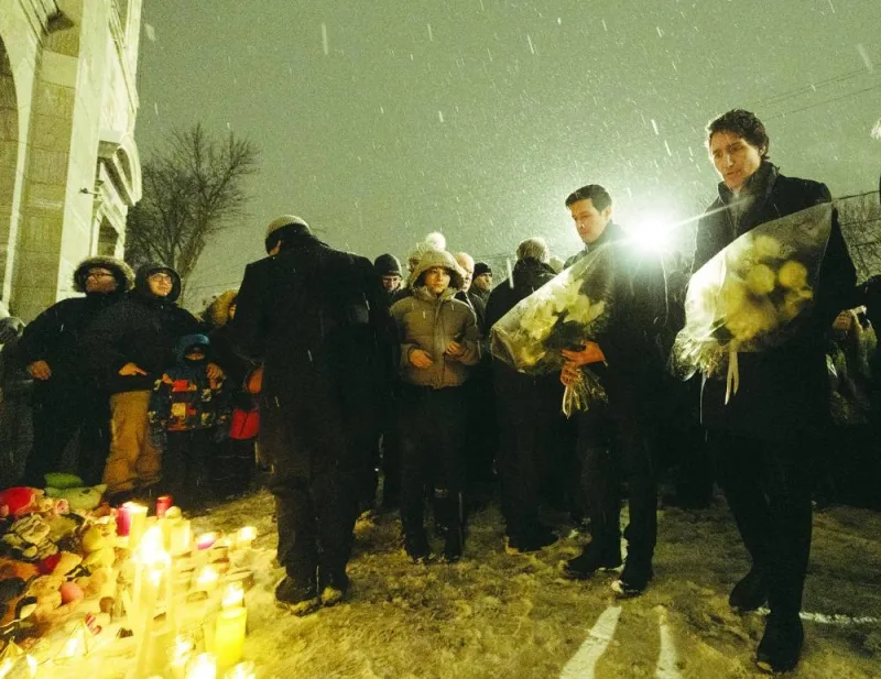 Canada’s Prime Minister Justin Trudeau and Laval mayor Stephane Boyer lay flowers at a vigil in honour of the daycare bus crash victims, in Laval, Quebec.