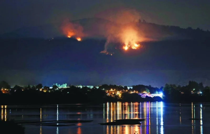 A forest fire approaches the Chilean town of Chiguayante, in the province of Concepcion, early on Thursday.