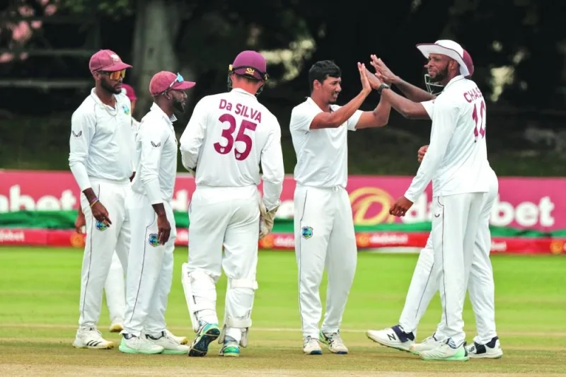 West Indies’ Gudakesh Motie (second from right) celebrates with teammates after taking a Zimbabwe wicket on the third day of the second and final Test in Bulawayo yesterday.
